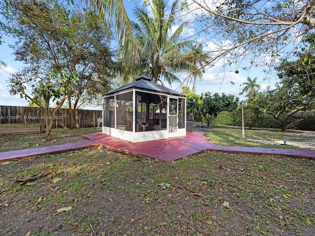 view of yard featuring a patio and a sunroom