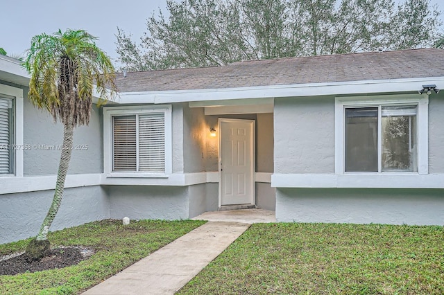 doorway to property featuring a yard