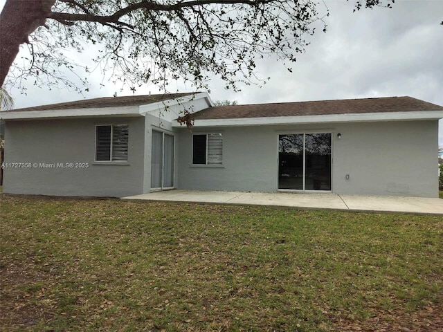 rear view of property with a patio area and a yard