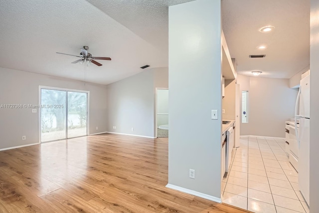 kitchen with light wood-type flooring, dishwasher, ceiling fan, and a textured ceiling