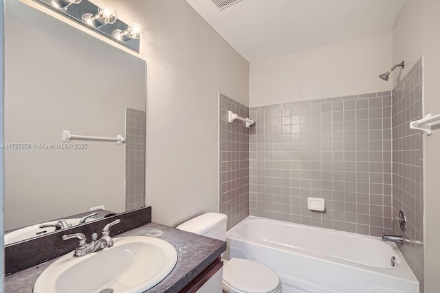 full bathroom featuring vanity, toilet, and tiled shower / bath