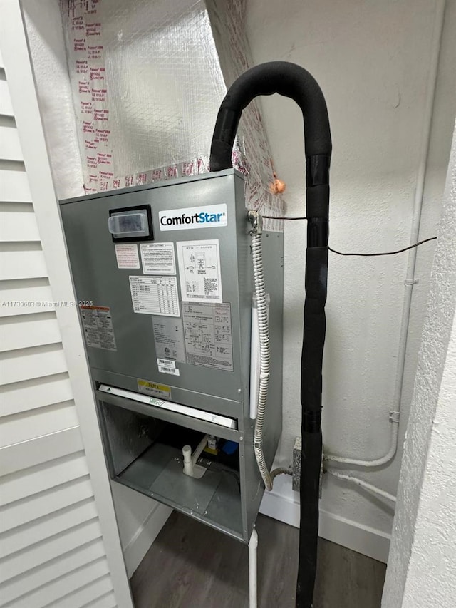 utility room featuring heating unit