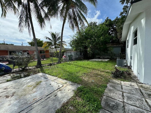 view of yard with a patio area and central air condition unit