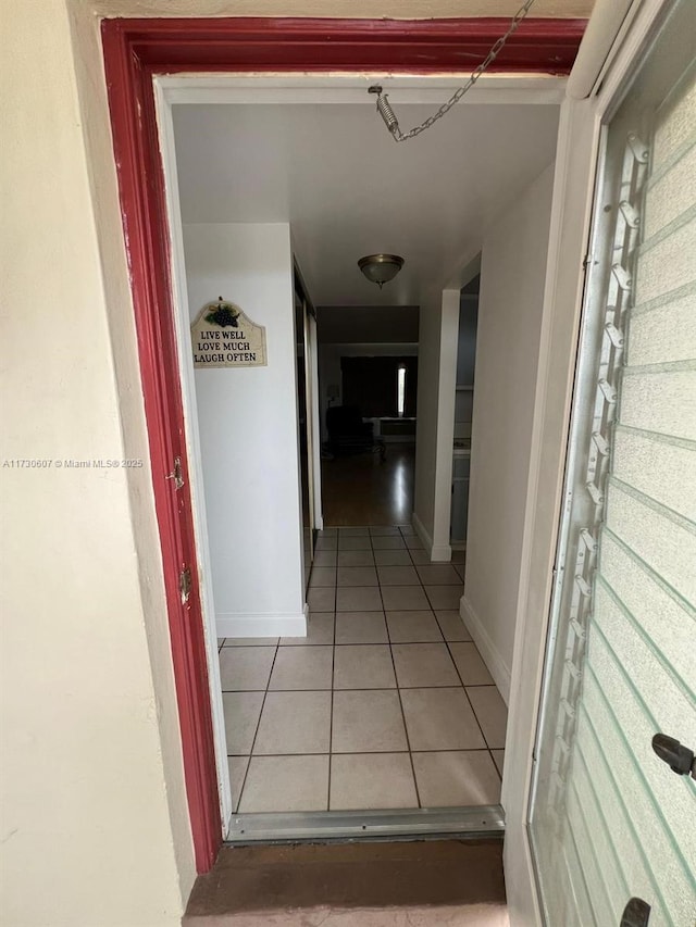 hallway with tile patterned floors