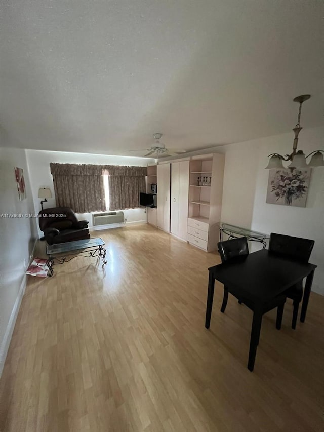 living room with ceiling fan and light hardwood / wood-style flooring