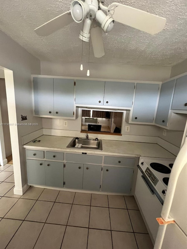 kitchen featuring sink, ceiling fan, and light tile patterned floors