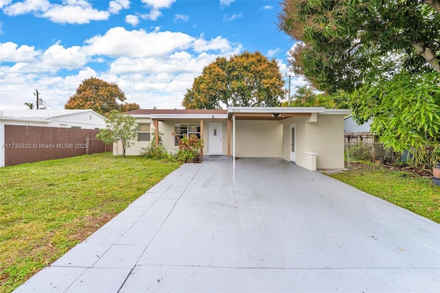 view of front facade with a carport and a front lawn