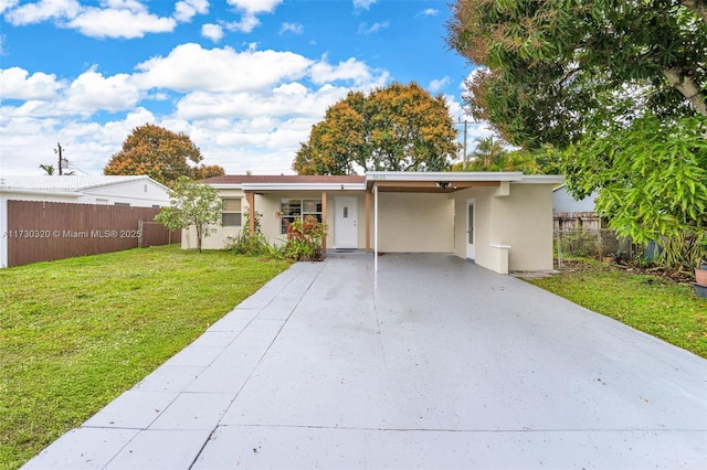 view of front facade with a carport and a front yard