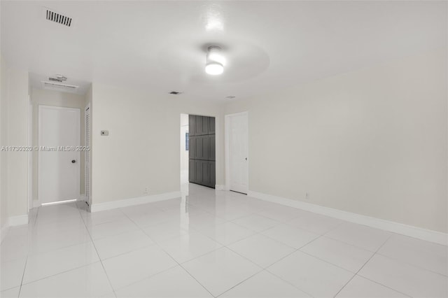 unfurnished room featuring light tile patterned flooring