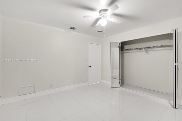 unfurnished bedroom with light tile patterned floors, ceiling fan, and a closet