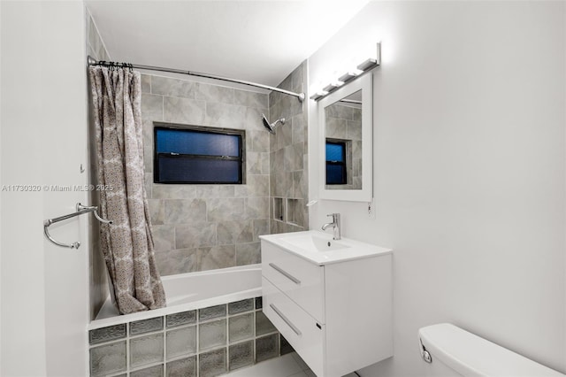 full bathroom with shower / tub combo, vanity, and toilet