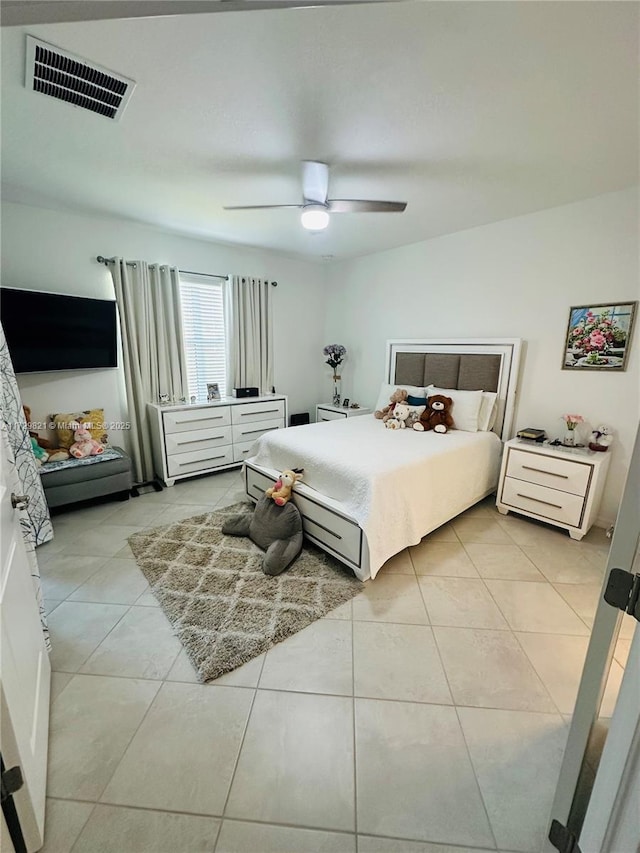 tiled bedroom with ceiling fan