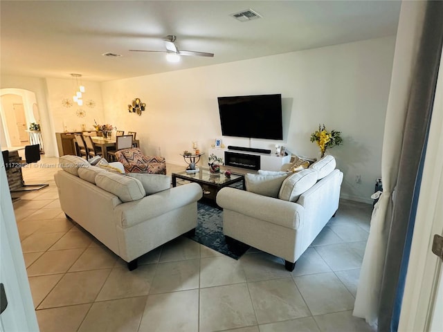 tiled living room with ceiling fan