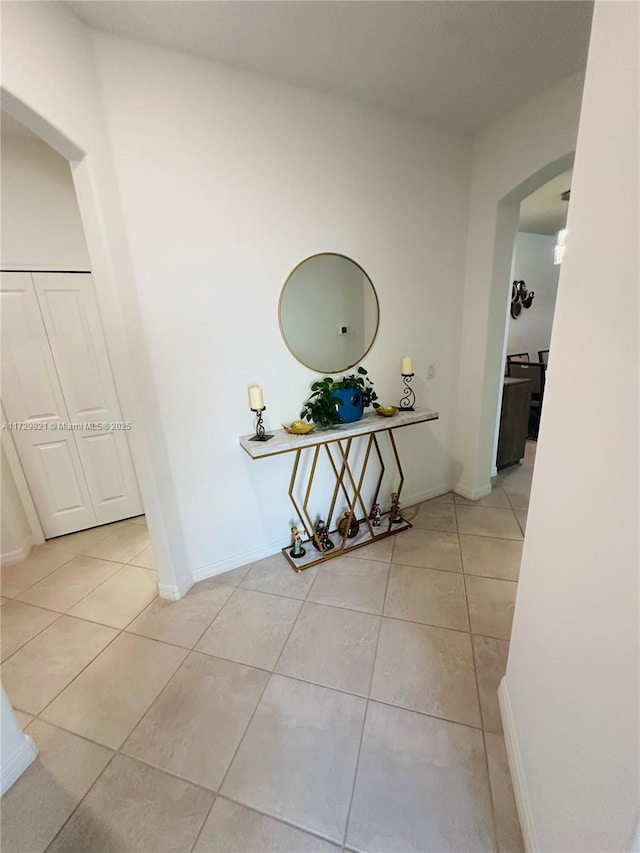 hall featuring light tile patterned floors