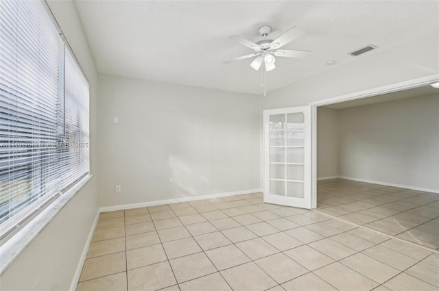 tiled empty room with ceiling fan