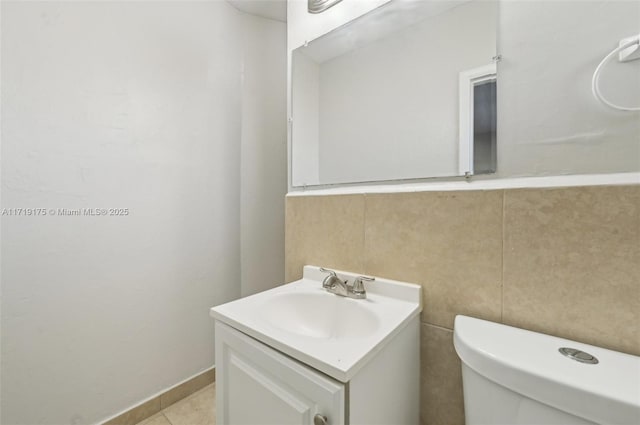 bathroom with vanity, toilet, and tile patterned flooring