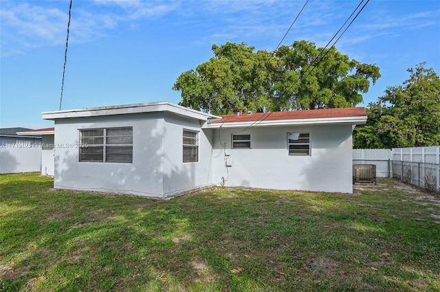 rear view of property featuring a yard