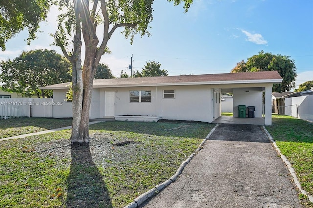 ranch-style home with a front lawn and a carport