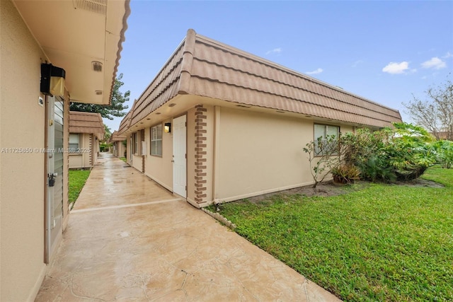 view of property exterior with a yard