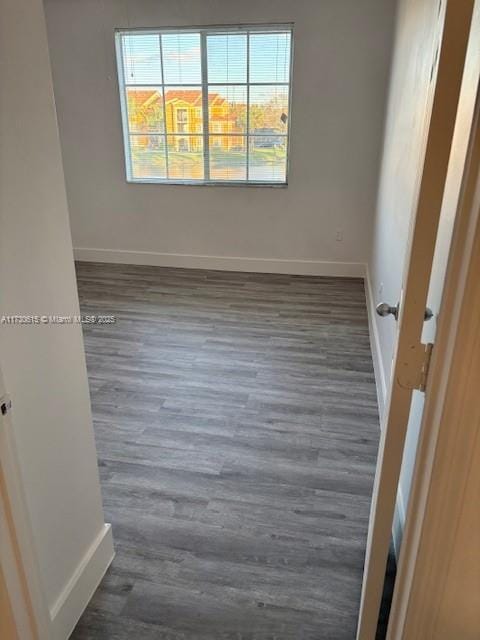 spare room with dark hardwood / wood-style floors