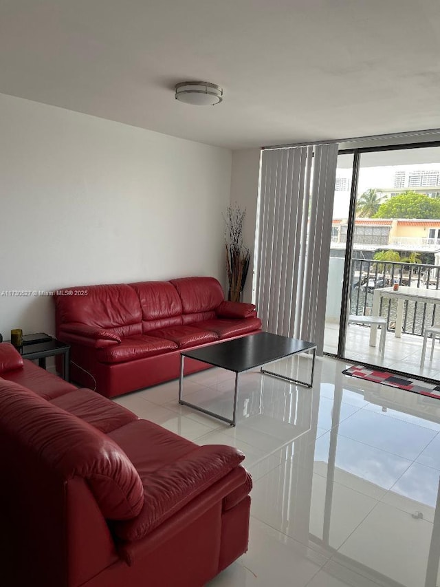 living room featuring a wall of windows and light tile patterned floors