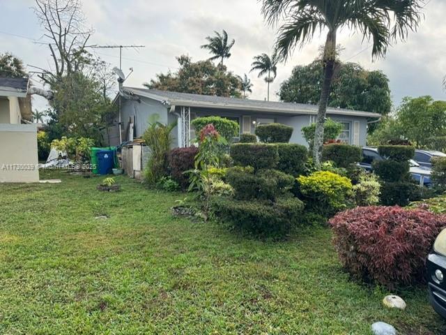 view of side of home with a lawn