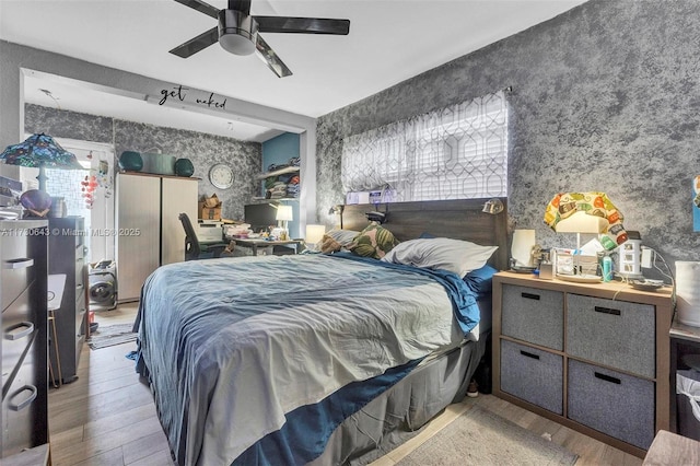 bedroom with light hardwood / wood-style floors and ceiling fan