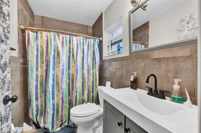 bathroom featuring toilet, a textured ceiling, tile walls, a shower with shower curtain, and vanity