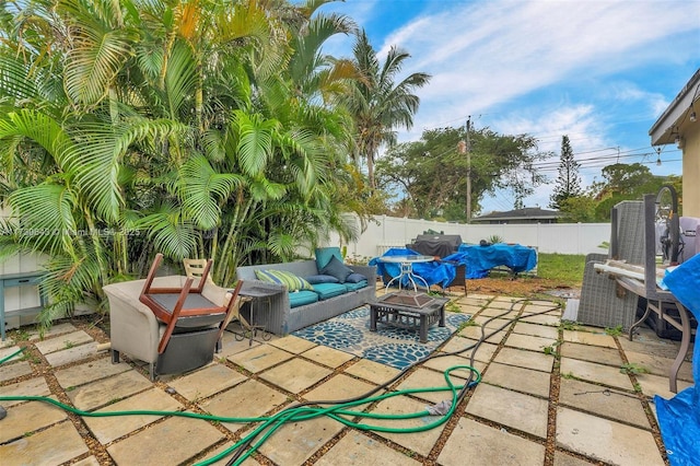 view of patio / terrace with an outdoor living space with a fire pit