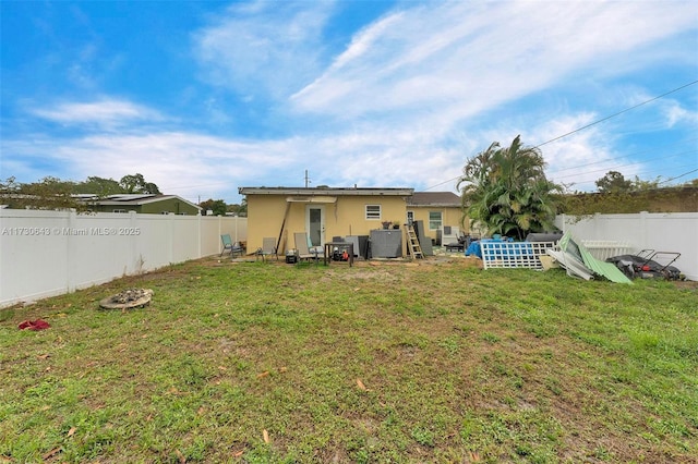 rear view of property with a yard