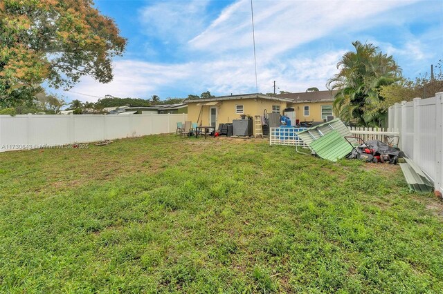 back of house with a lawn