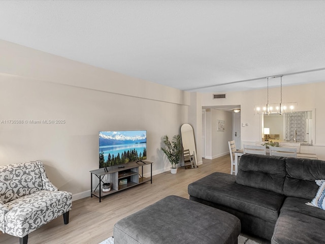 living room featuring light hardwood / wood-style floors and sink