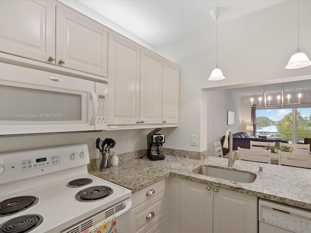 kitchen with sink, white appliances, and white cabinets