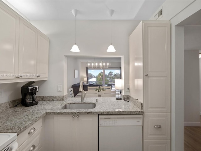 kitchen with light stone countertops, sink, white cabinetry, and dishwasher