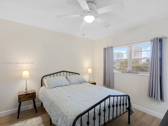 bedroom featuring hardwood / wood-style flooring and ceiling fan