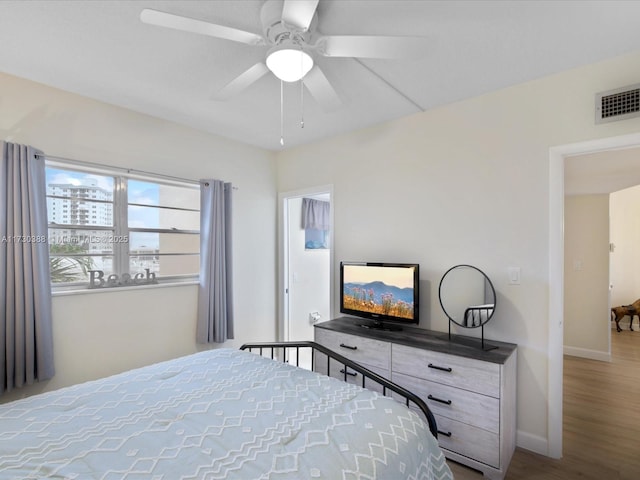 bedroom with hardwood / wood-style floors and ceiling fan