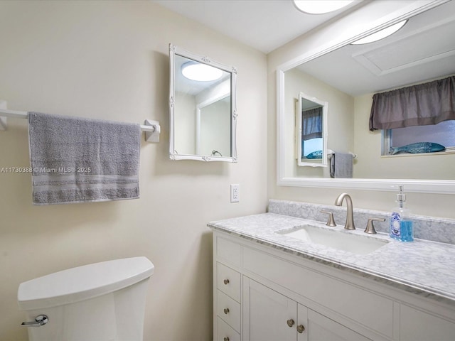 bathroom with vanity and toilet