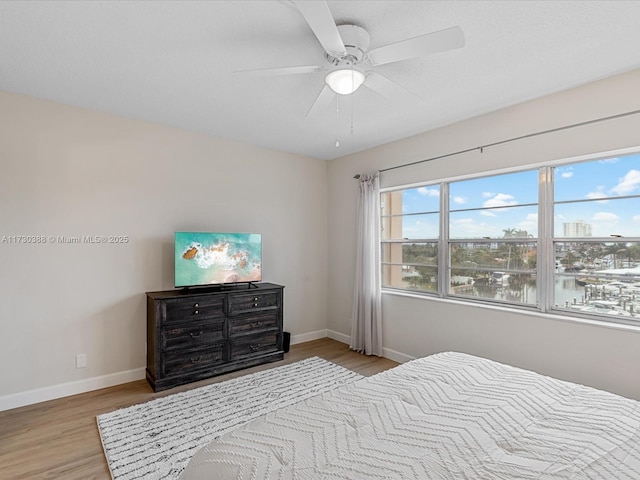 bedroom featuring light hardwood / wood-style flooring and ceiling fan