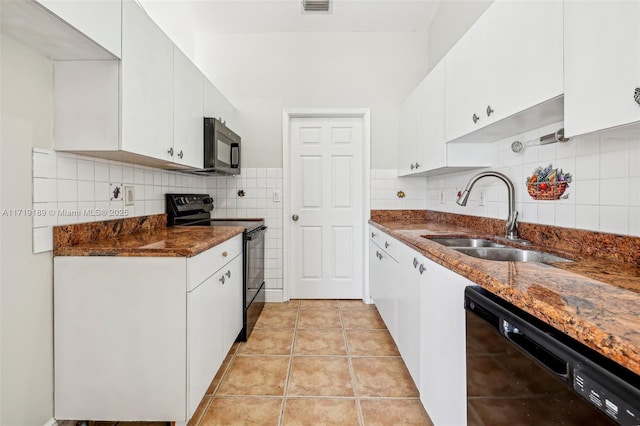 kitchen featuring sink, white cabinetry, light tile patterned flooring, black appliances, and decorative backsplash