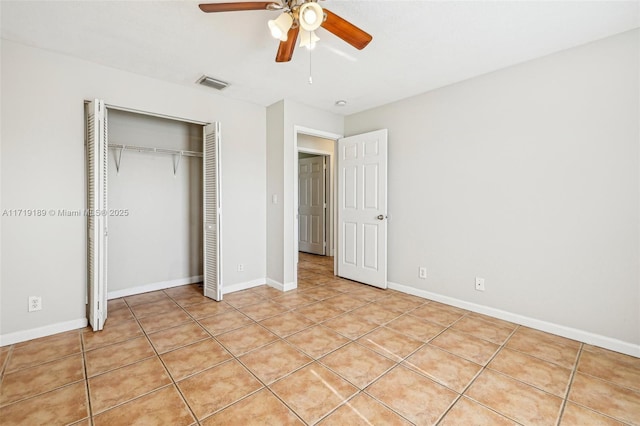 unfurnished bedroom featuring ceiling fan, light tile patterned floors, and a closet