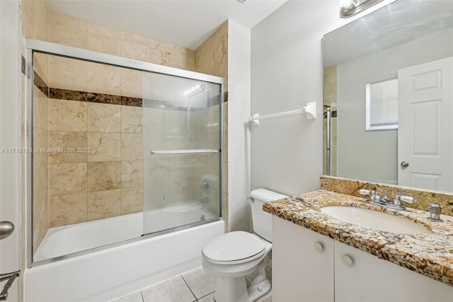 full bathroom with shower / bath combination with glass door, vanity, toilet, and tile patterned flooring