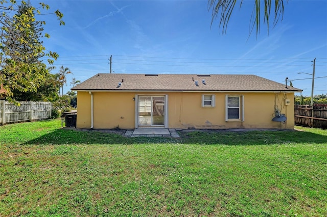 rear view of house featuring a yard