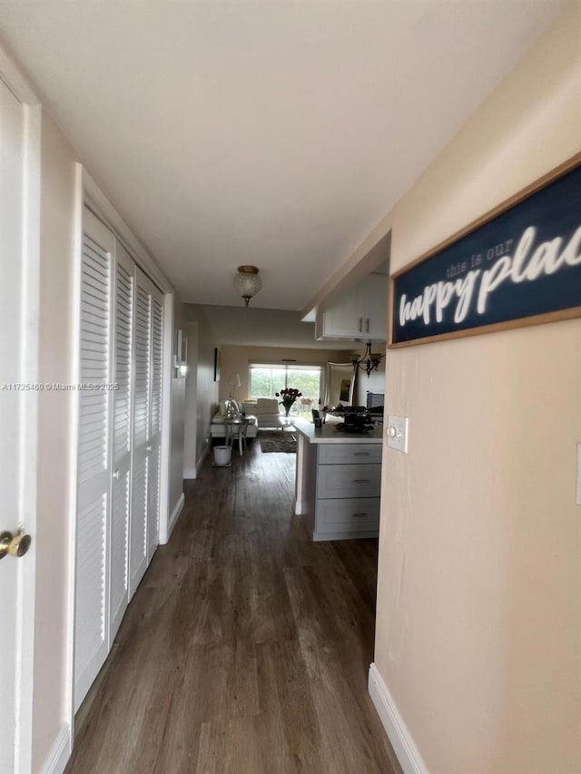 corridor with dark hardwood / wood-style floors