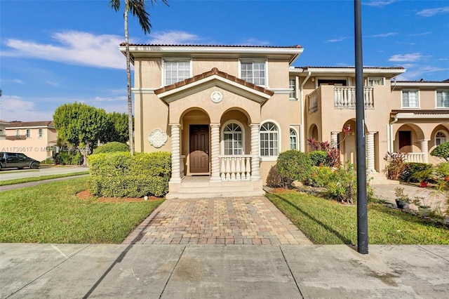 mediterranean / spanish-style home featuring a front yard