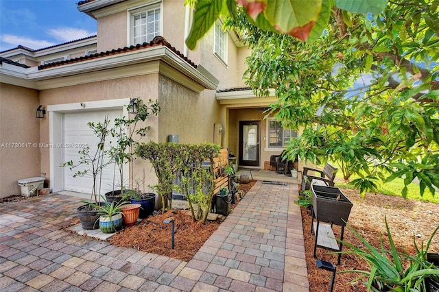 doorway to property with a patio area and a garage