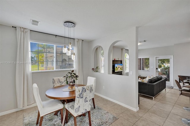 dining area featuring a notable chandelier and light tile patterned floors