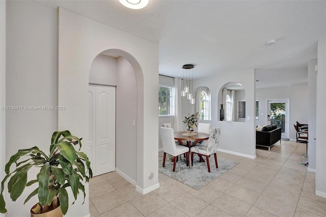 tiled dining space featuring a textured ceiling