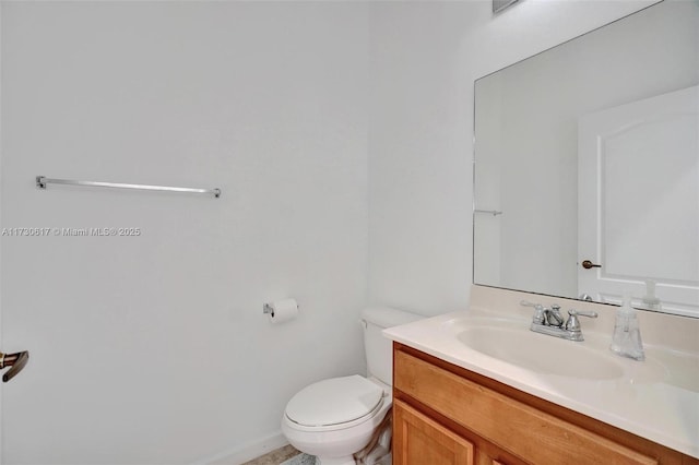 bathroom featuring toilet and vanity