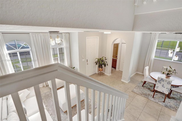 interior space with light tile patterned flooring and a wealth of natural light