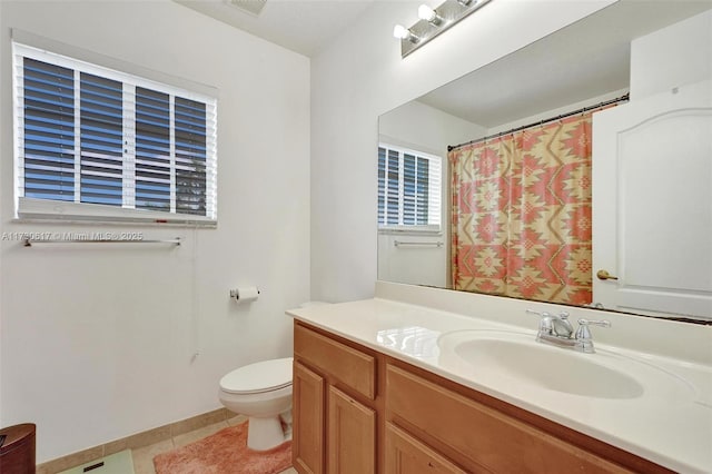 bathroom featuring vanity, toilet, tile patterned floors, and a shower with curtain